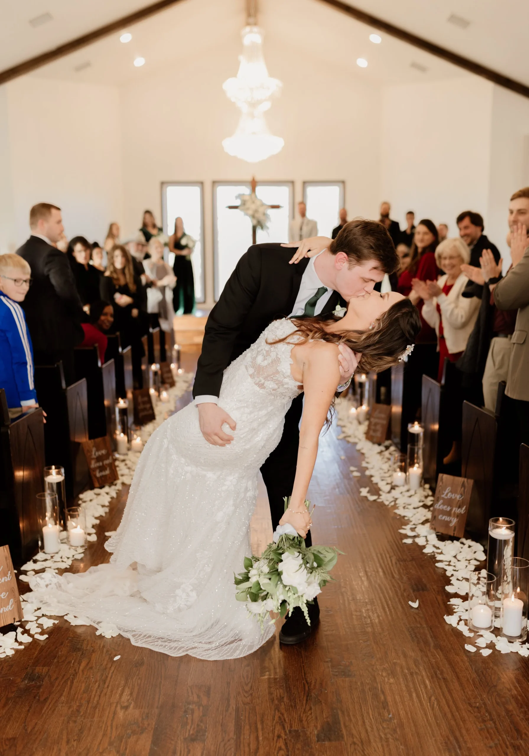 Bride and Groom kissing as they leave their wedding ceremony