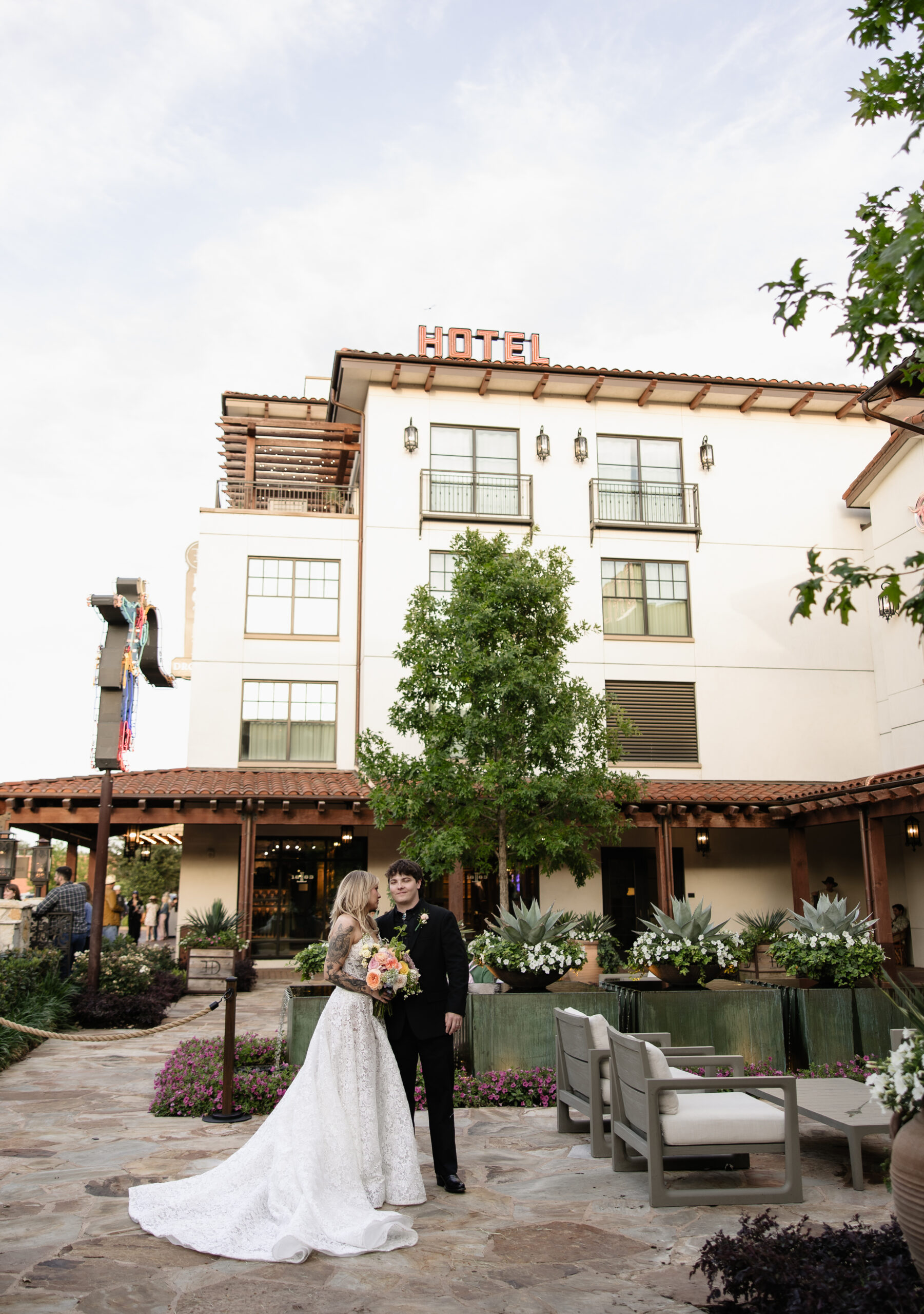 Bride and groom embrace in front of Hotel Drover in downtown Fort Worth