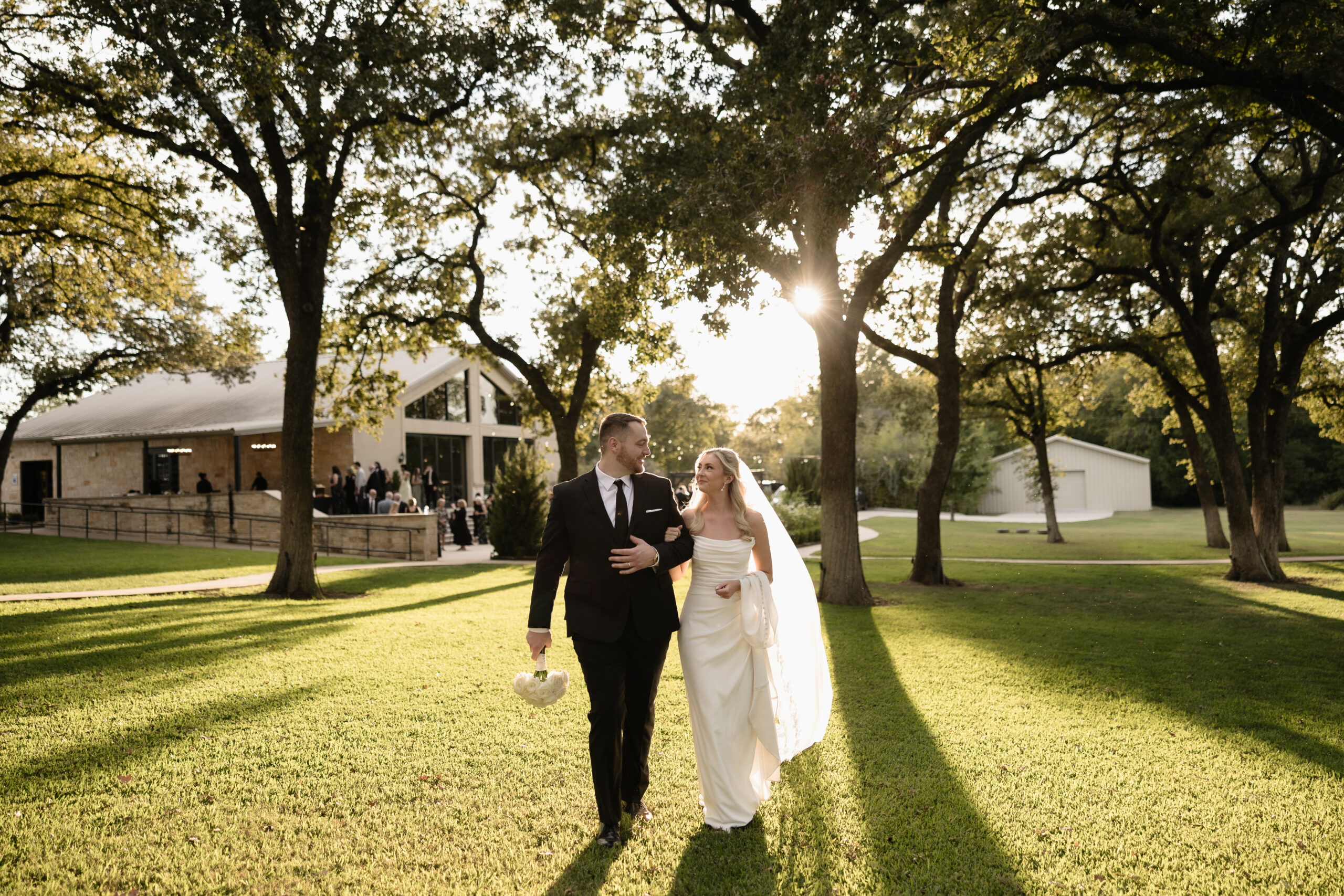 Bride and groom holding hands and walking.